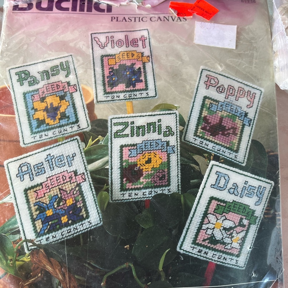 Assorted craft items including Bucilla Plastic Canvas Floral Seed Packet Set